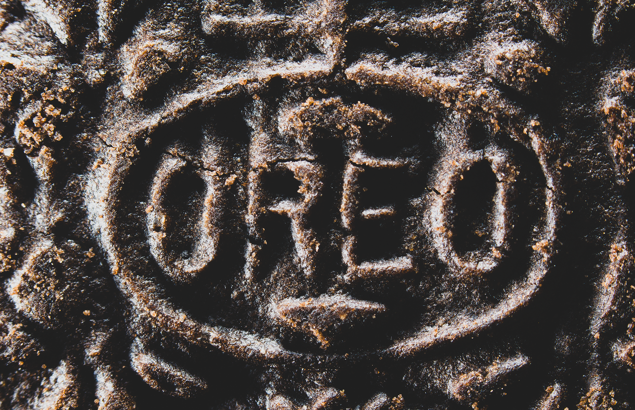 Close-up of an Oreo cookie showing the embossed ‘OREO’ text and textured surface.