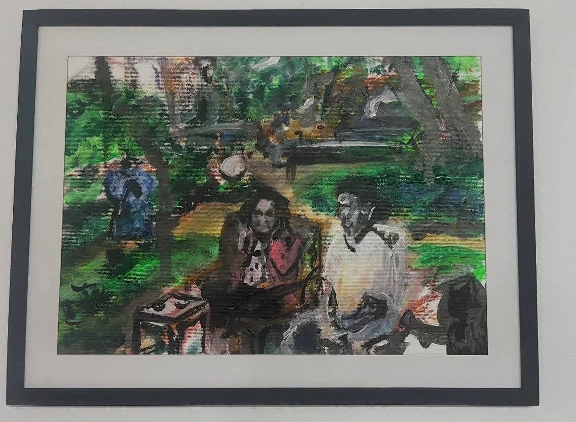 A framed impressionist painting of people in a park. Two women are sitting and talking in the foreground, with trees and other park visitors, some walking and some playing instruments, in the background.