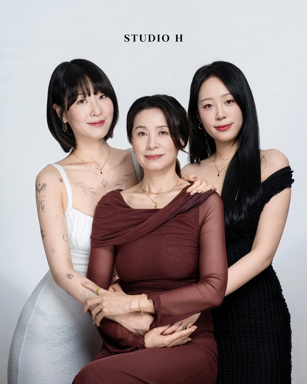 Three women posing together against a white background with the text 'STUDIO H' above them.