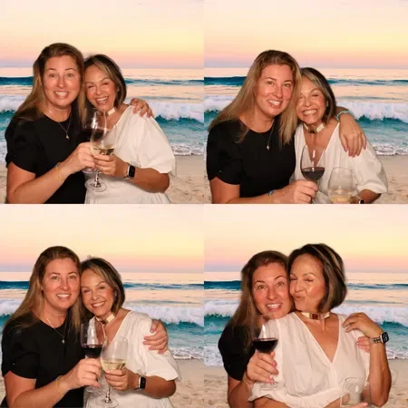 Four photos of two women enjoying drinks on the beach at sunset, smiling and hugging.