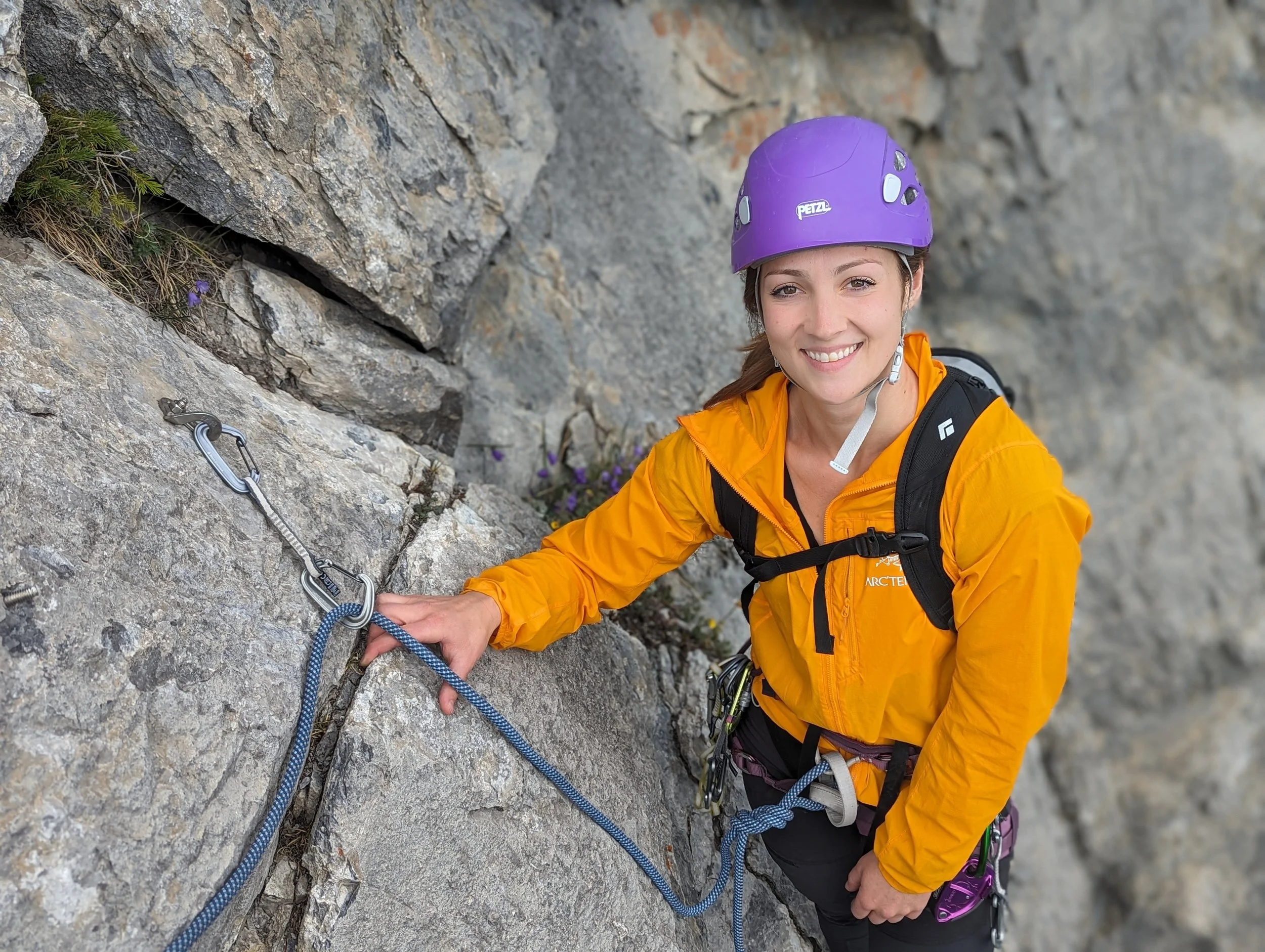Woman smiling rock climbing