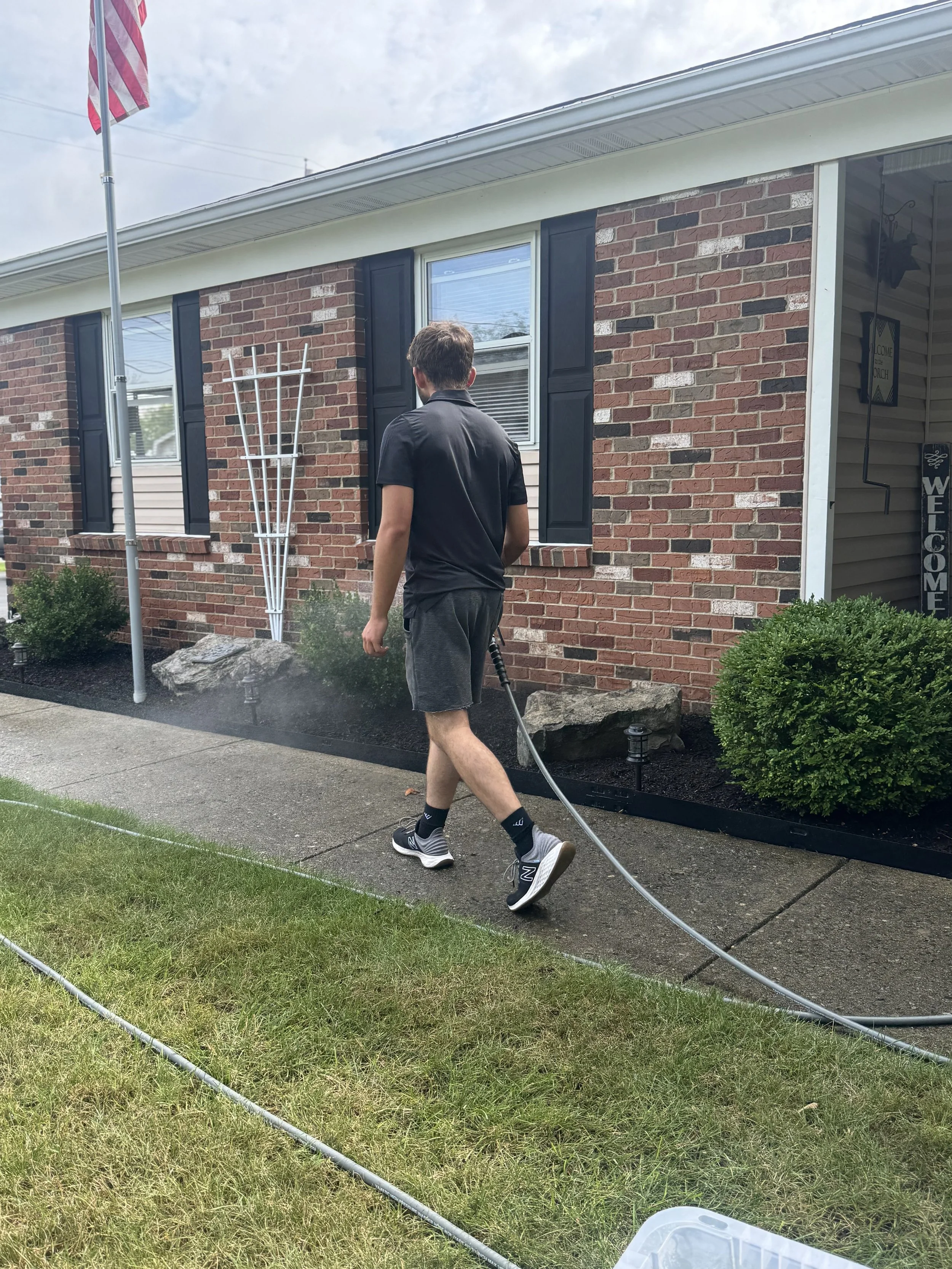 Side-by-side comparison of a house exterior with changes in the siding, with 'Before' on the left and 'After' on the right.