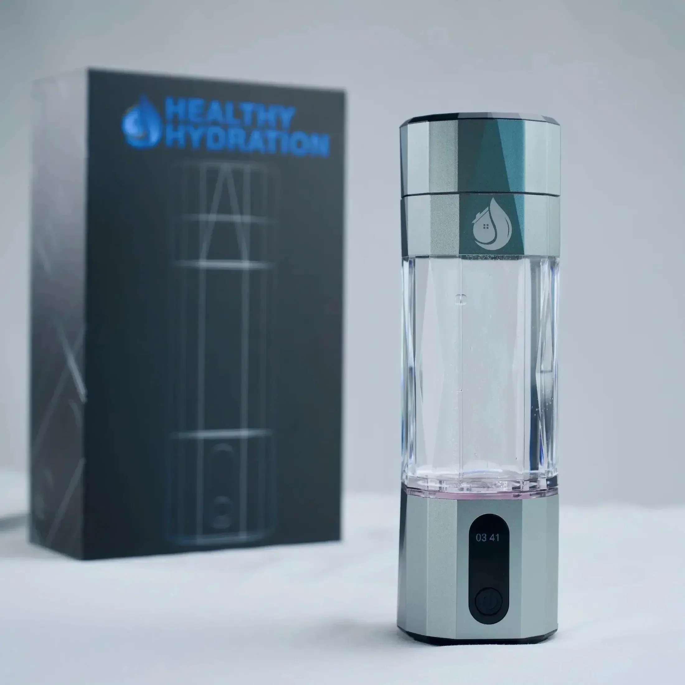 Portable mist humidifier with a digital display, next to a box labeled 'Healthy Hydration' with a drop of water and house icon.