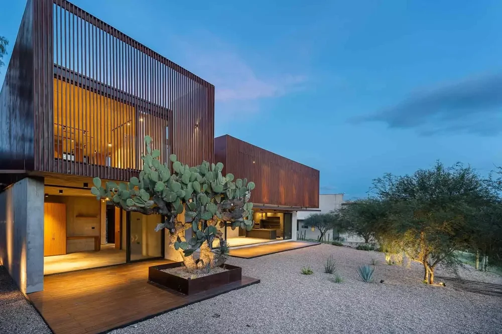 Timber-clad facade at dusk, Casa Estrato
