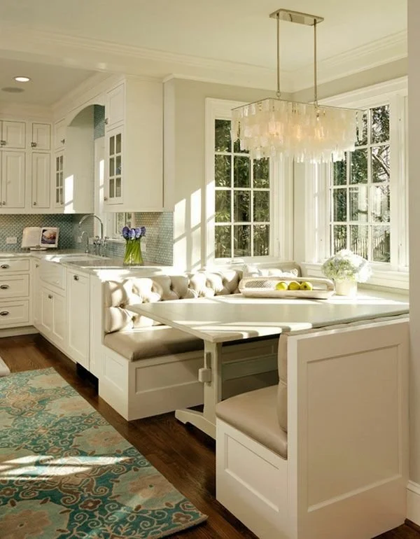 Espel contracting modern kitchen with white cabinets, granite countertops, a wooden island, and large windows with greenery outside.