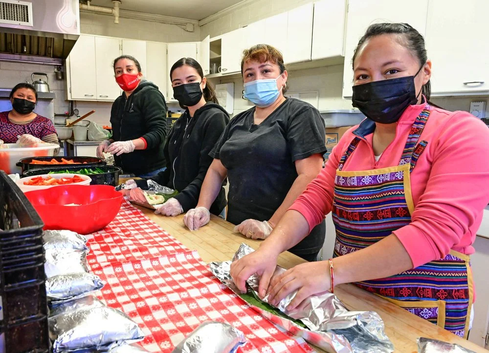 A group of ESWA members making tamales together.