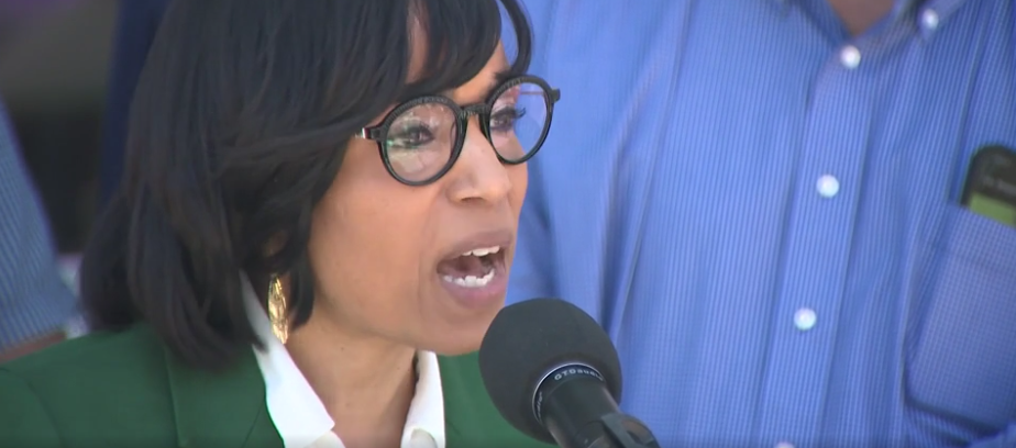 U.S. Senator Angela Alsobrooks speaks into a microphone at the rally / vigil