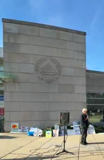 A man speaks at an NIH vigil