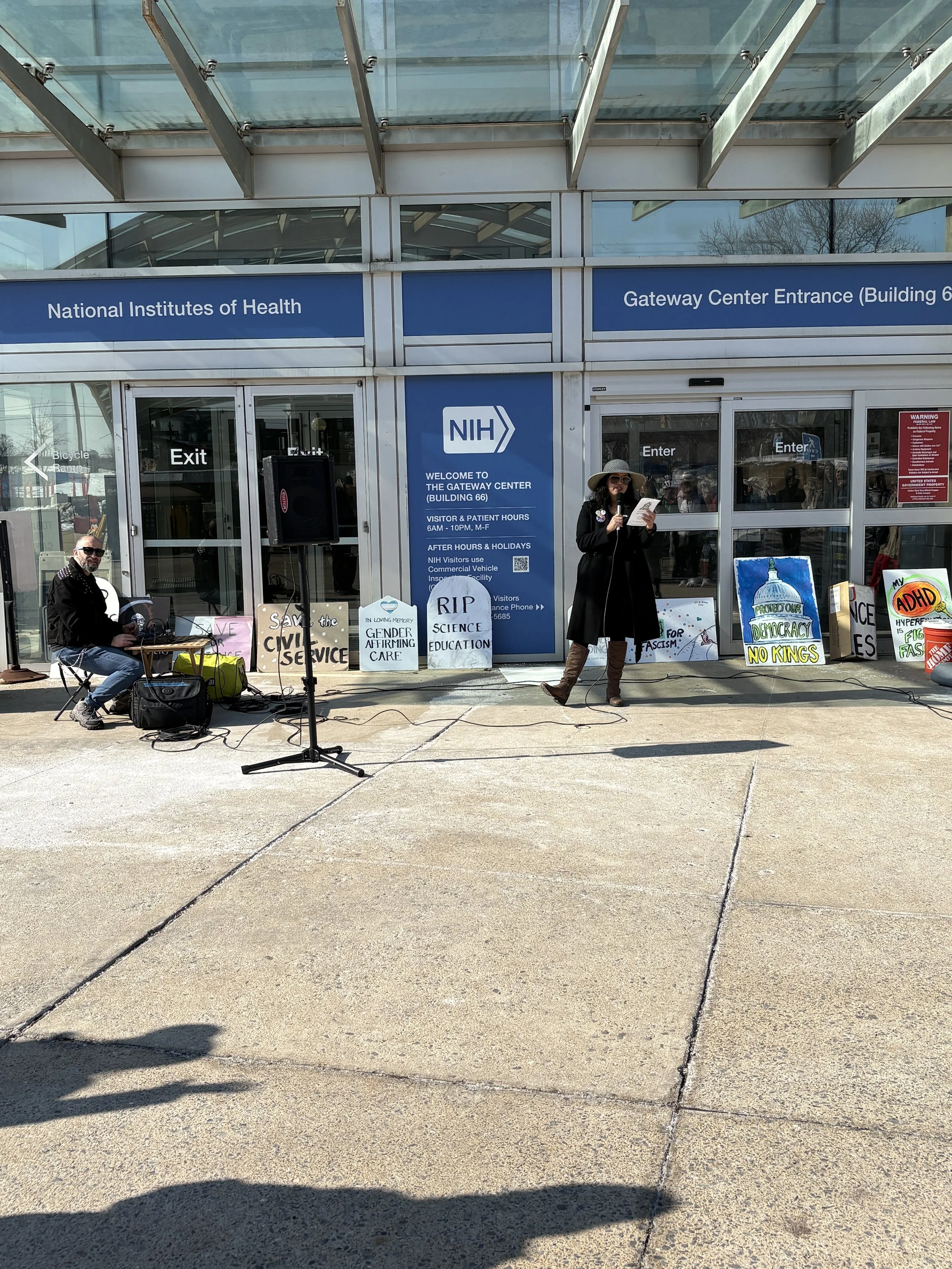 The emcee and sound board person at an NIH vigil