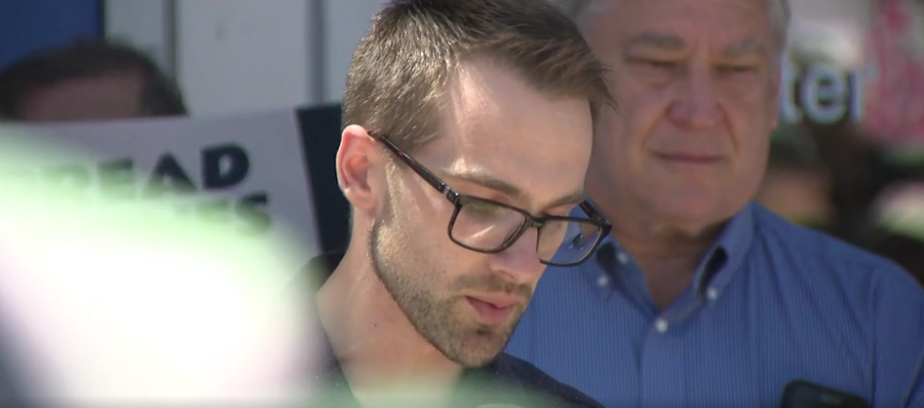 A man speaking at the vigil