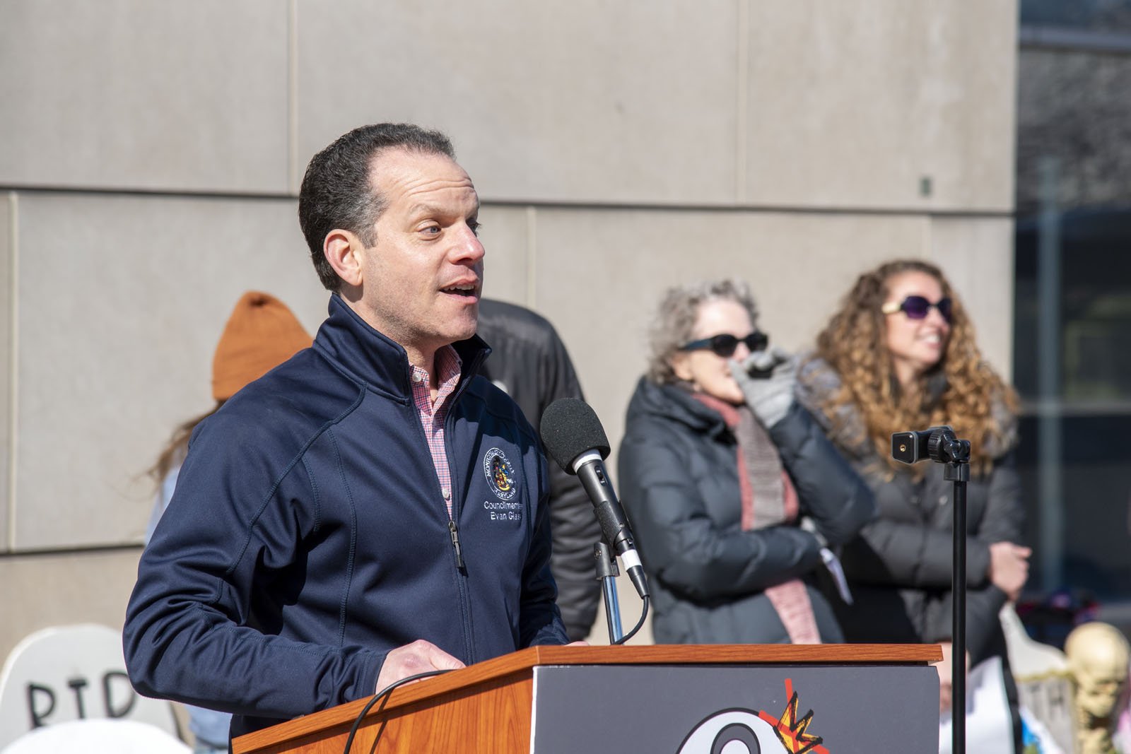 A man speaks at the NIH vigil
