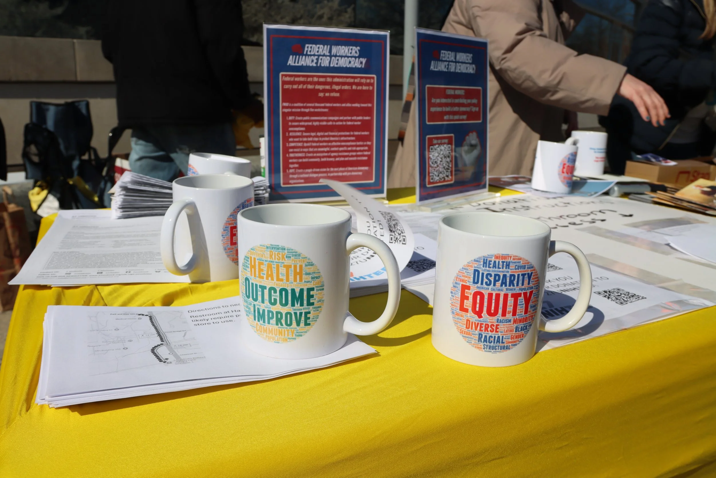 coffee mugs on the merch table