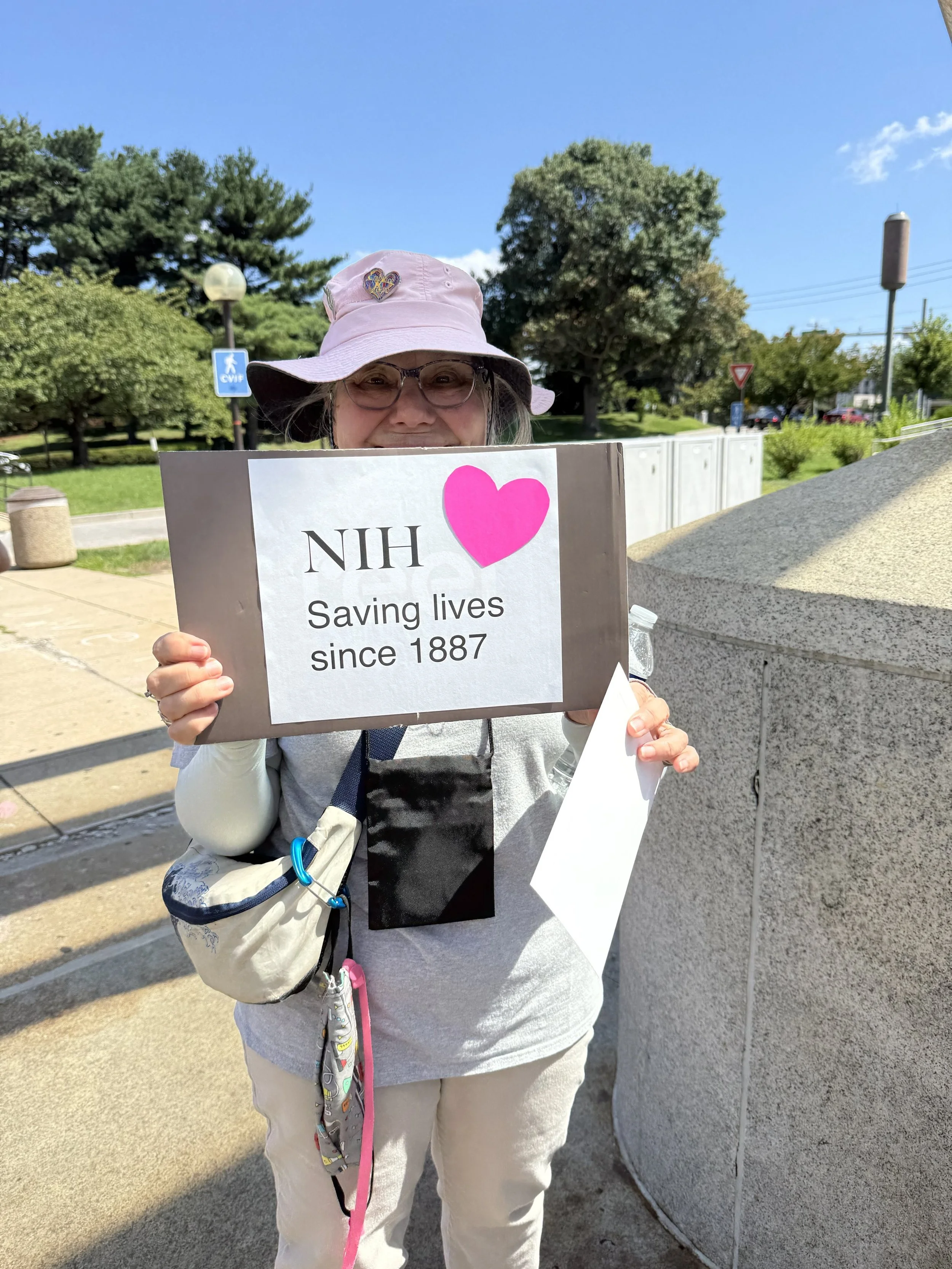 Women Standing with an NIH sign