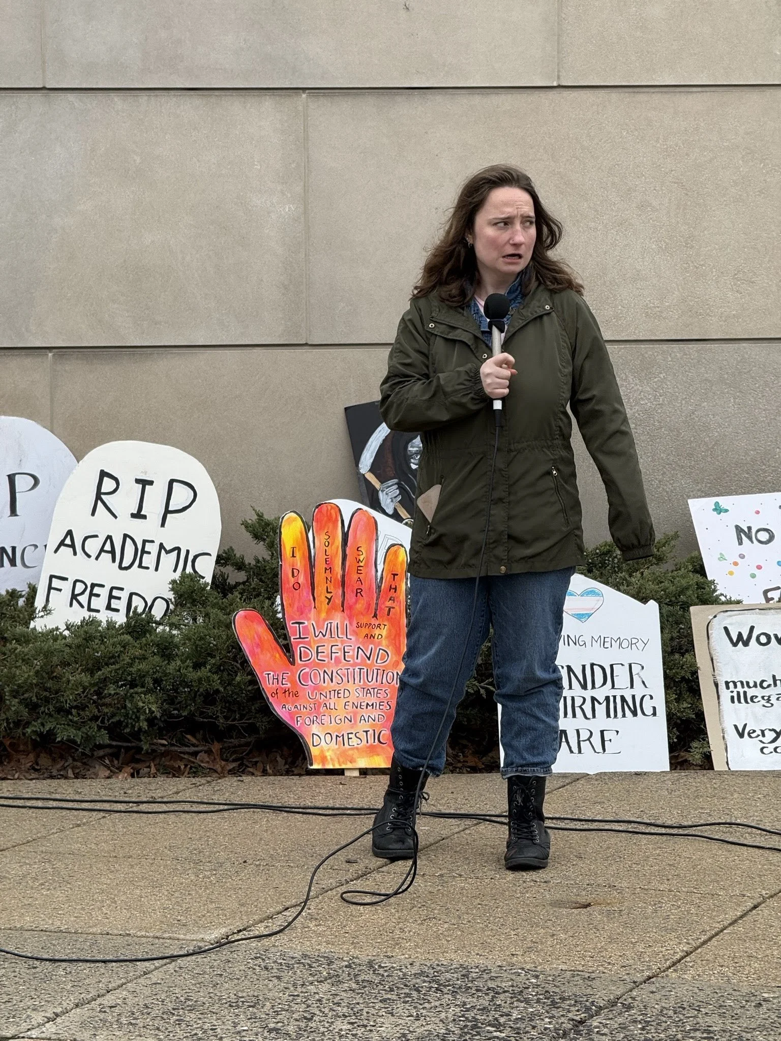 A woman speaking at the vigil