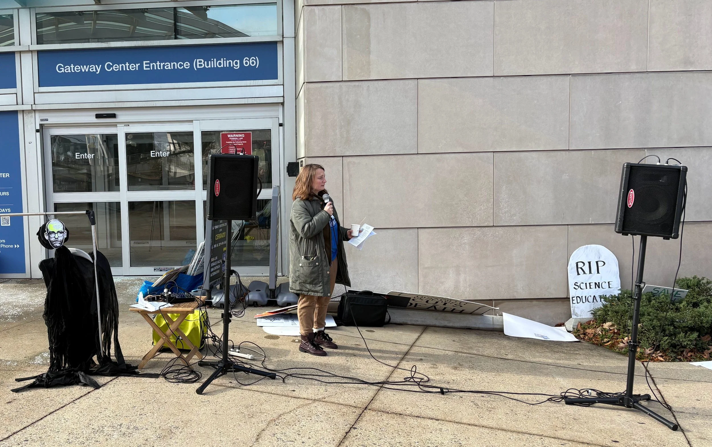 A woman speaks at an NIH vigil