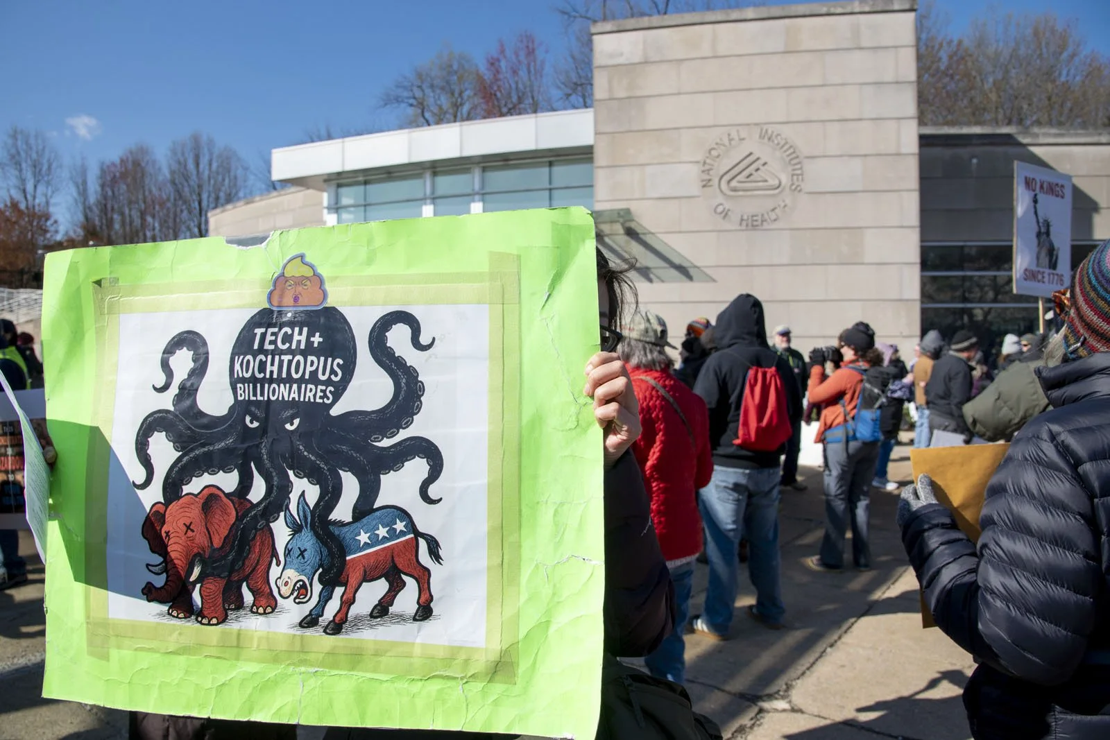 A protest sign showing an octopus holding an elephant and a donkey