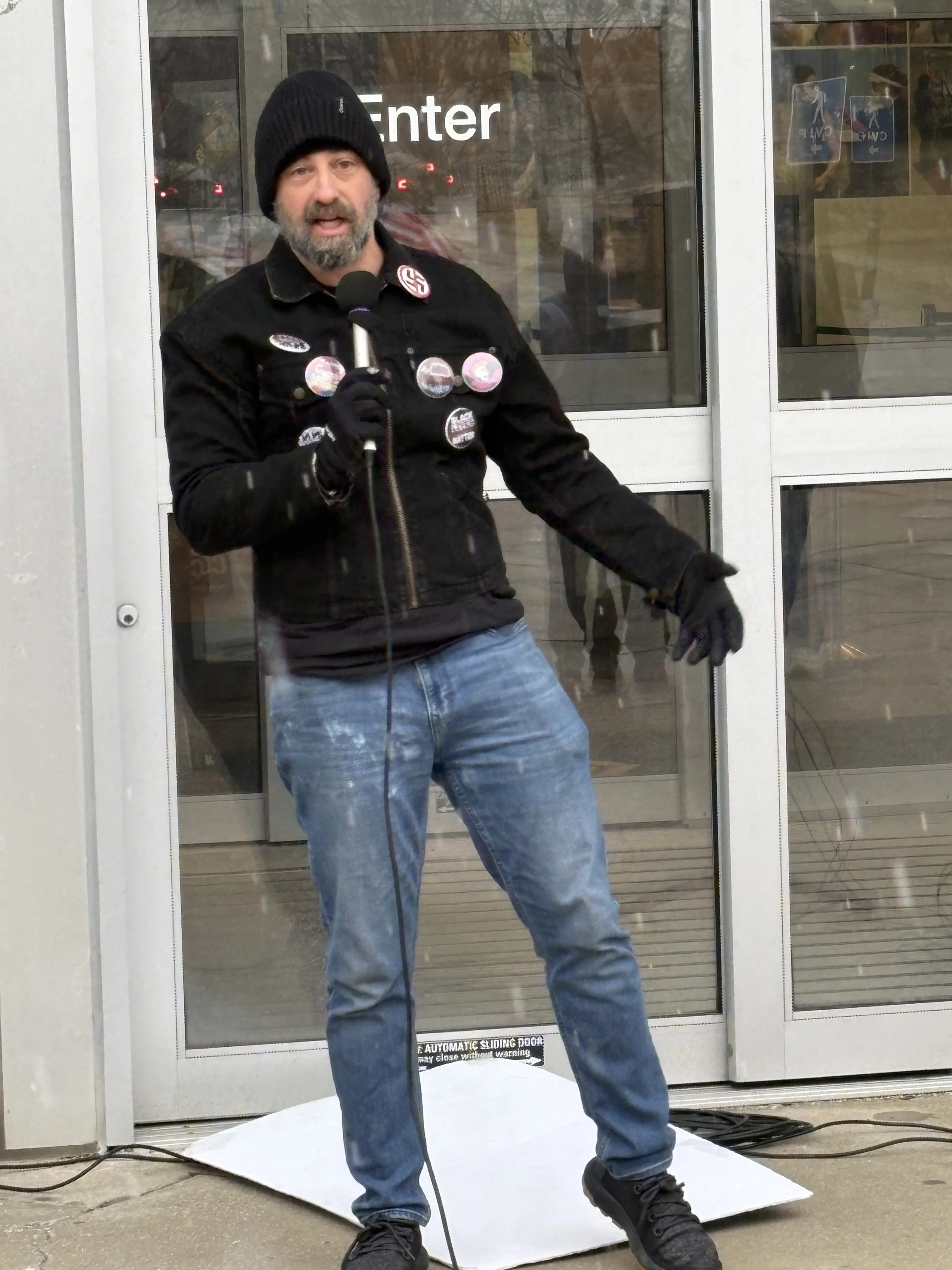 A man speaks at the NIH vigil