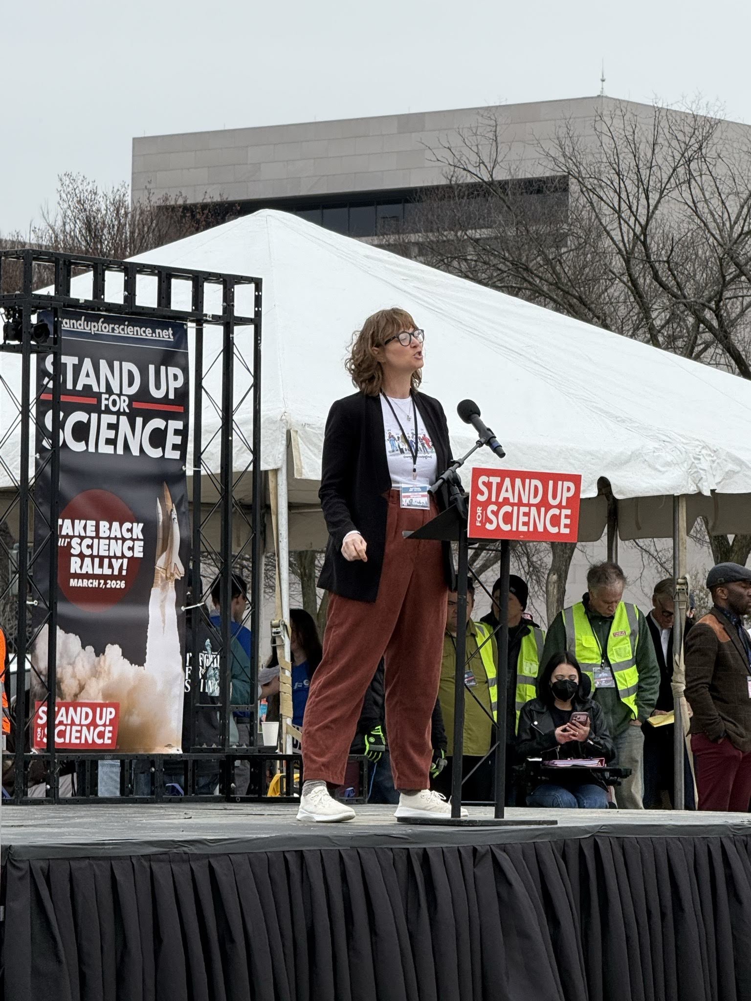 A woman speaking at the rally