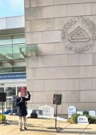 A man speaks at an NIH vigil