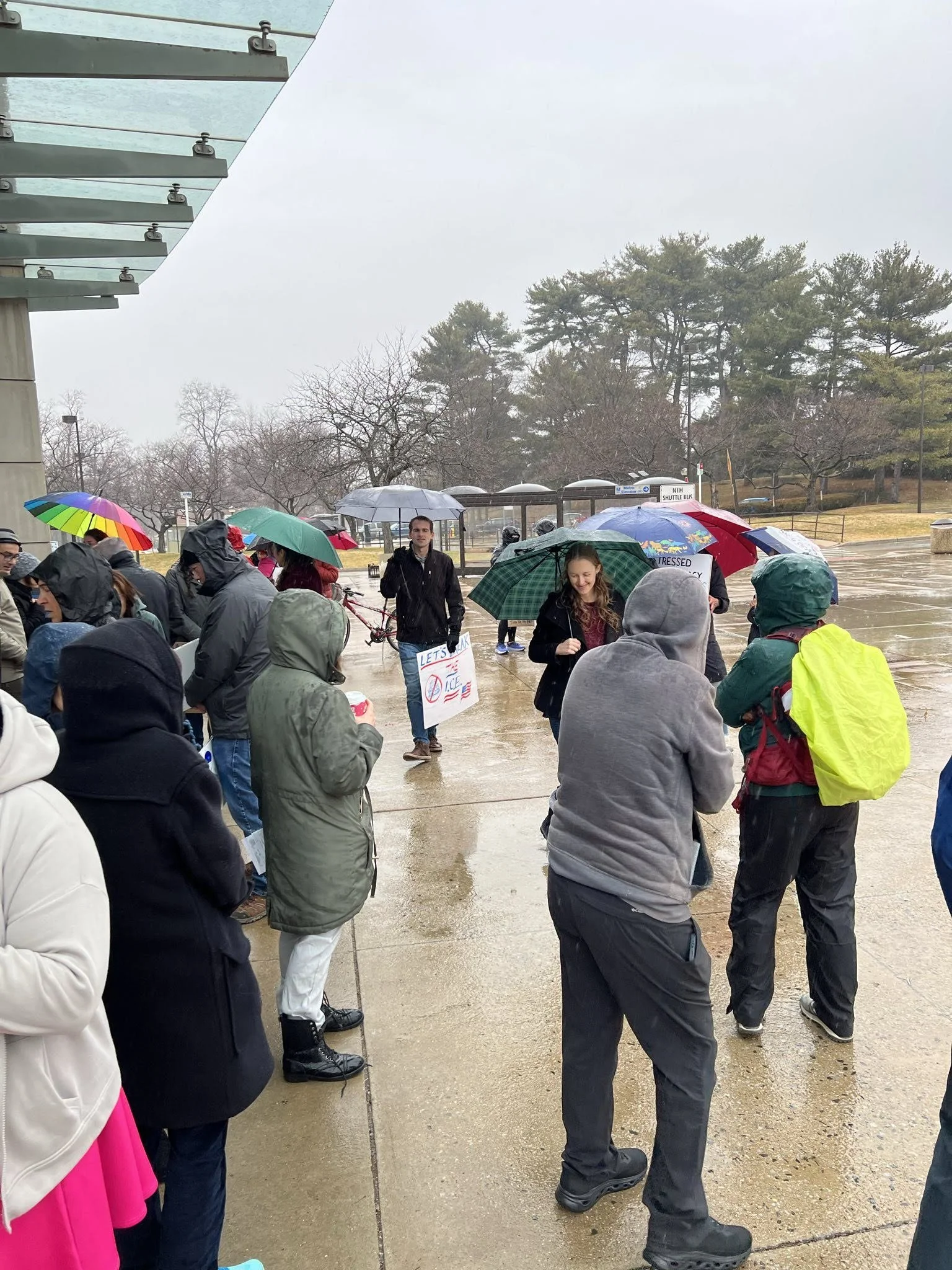 A crowd in the rain at an NIH vigil