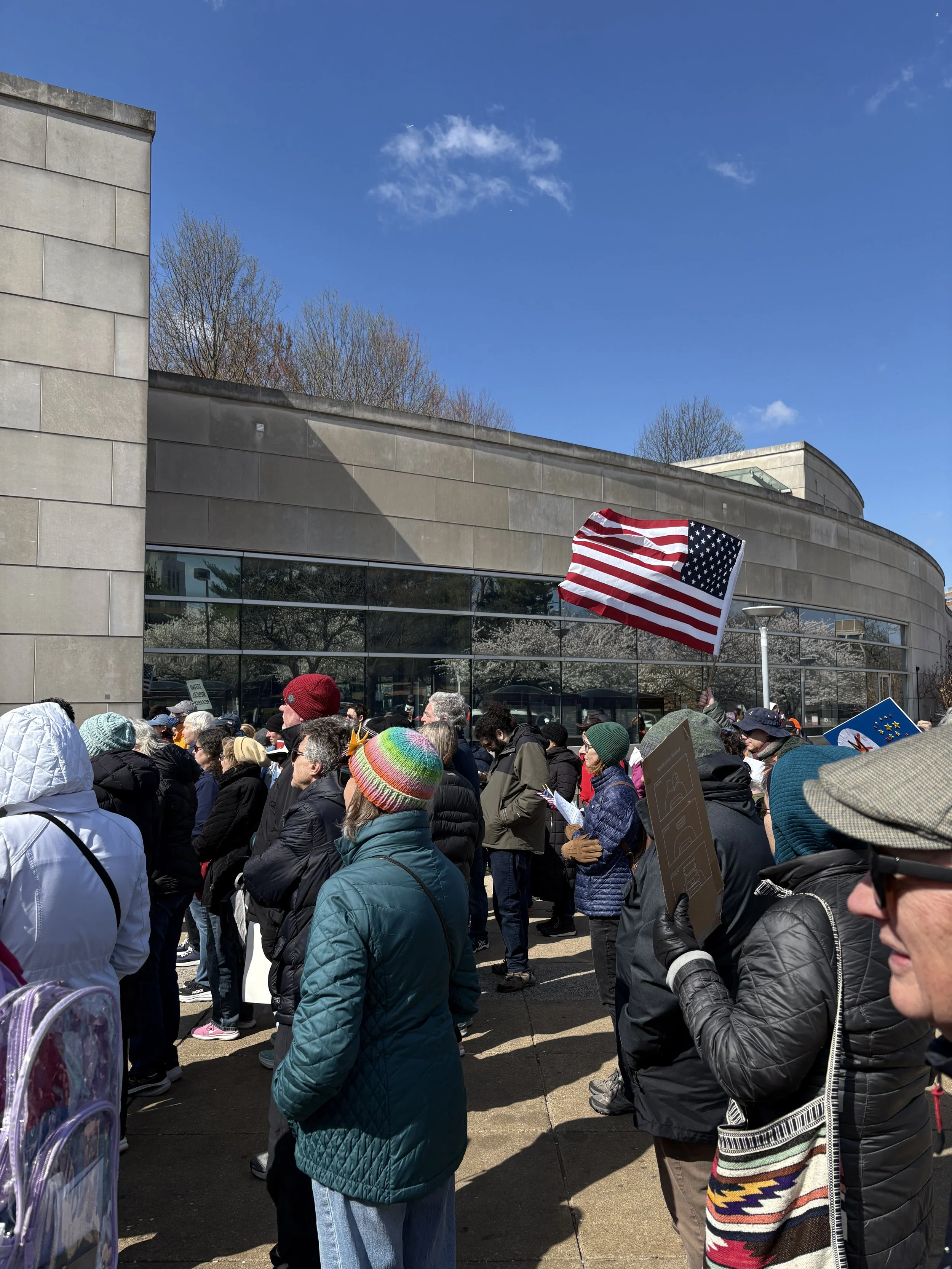 A member of the crowd holding an American flag