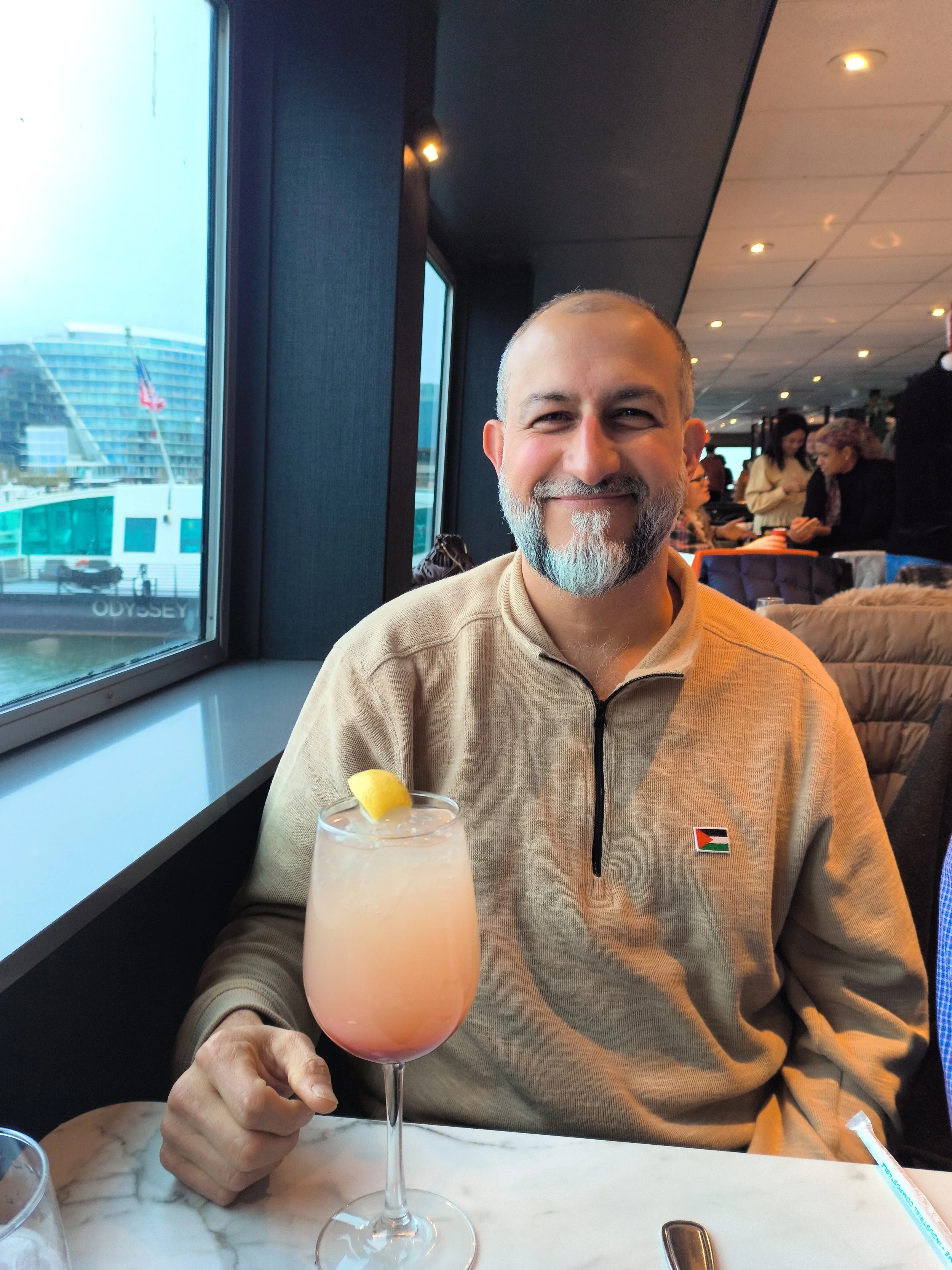 Man at table with drink in front of him