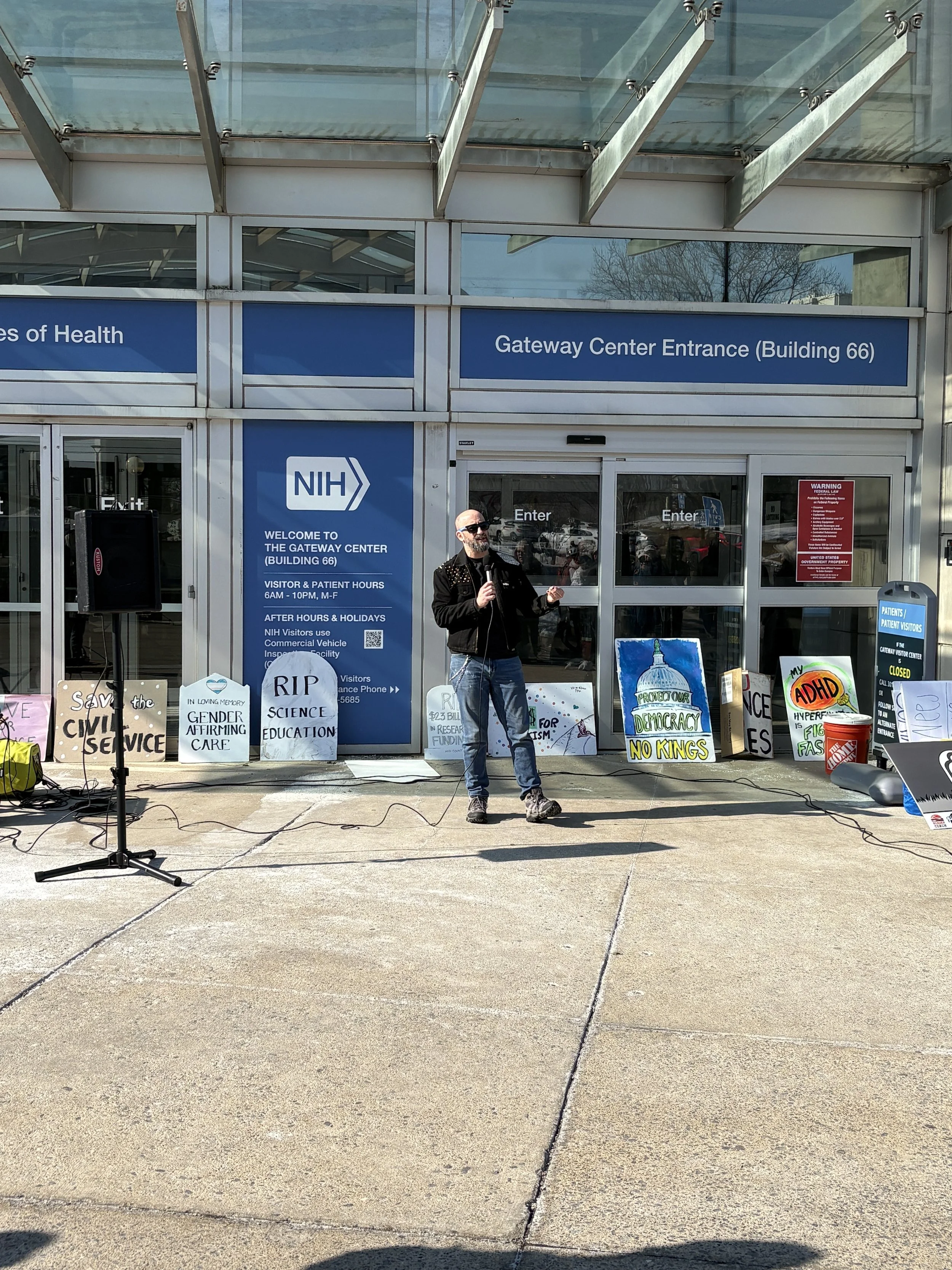 A person speaking at an NIH vigil