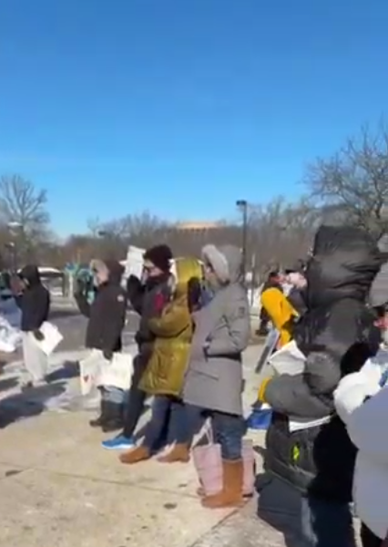 People with their right hand raised, reciting the oath of office at the end of an NIH vigil