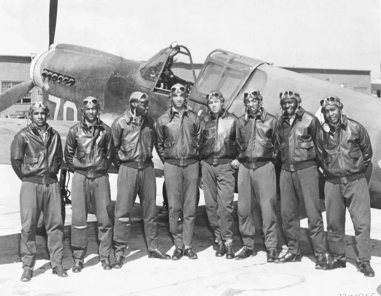 Tuskegee Airmen in front of fighter plane 1942-43
