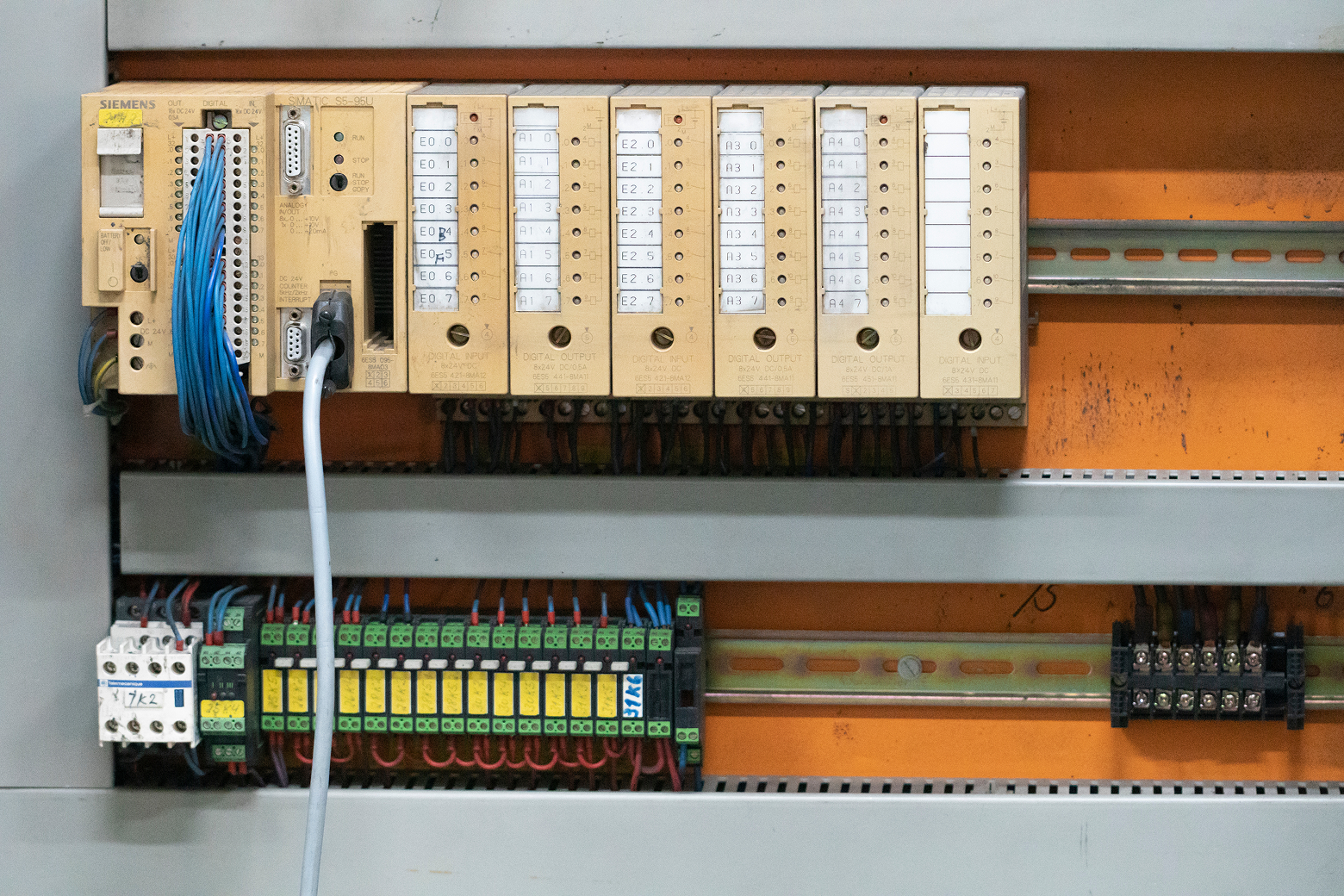 Electrical control panel with multiple modules and wiring for industrial automation. Old PLC Siemens S5