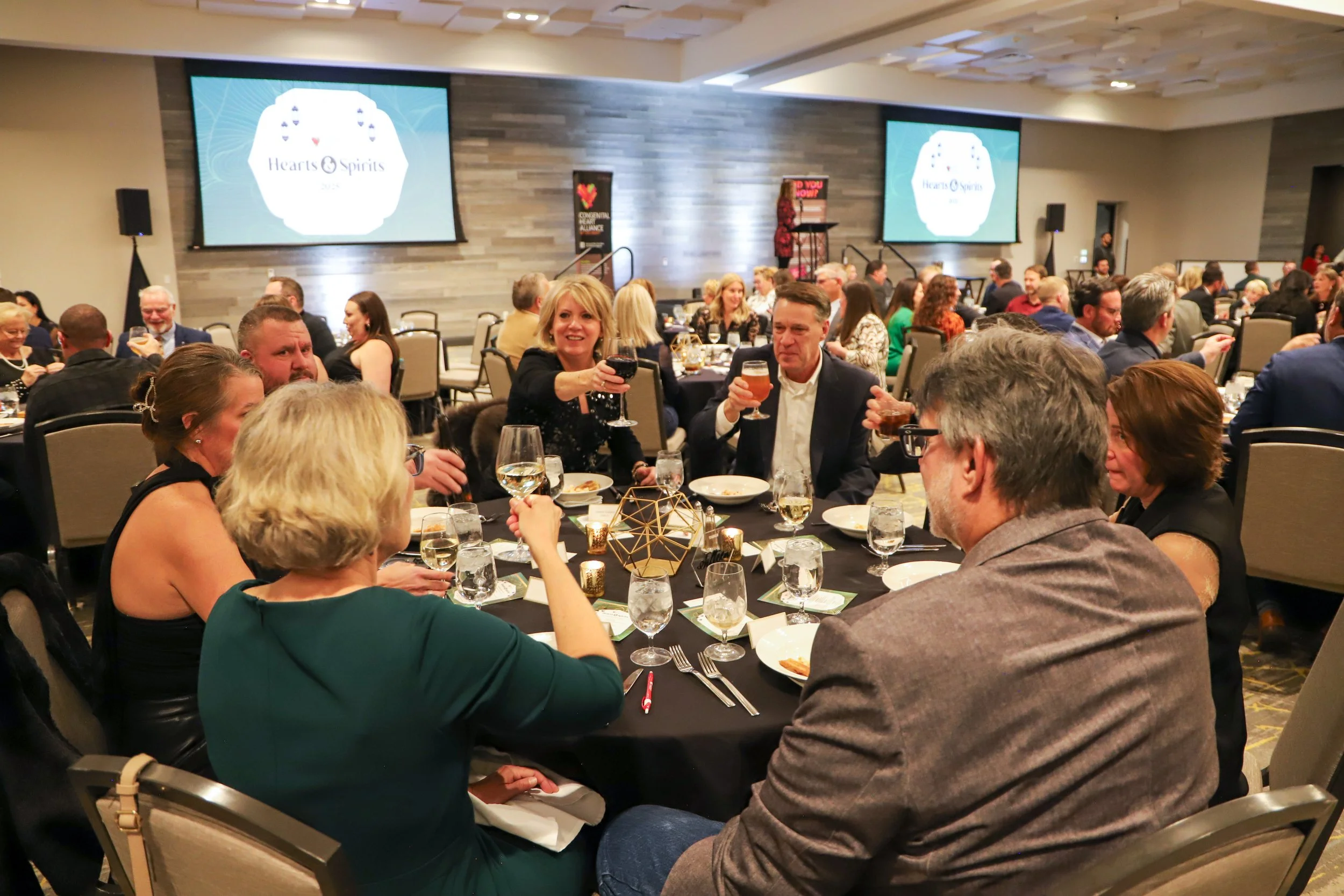 people at event doing a cheers