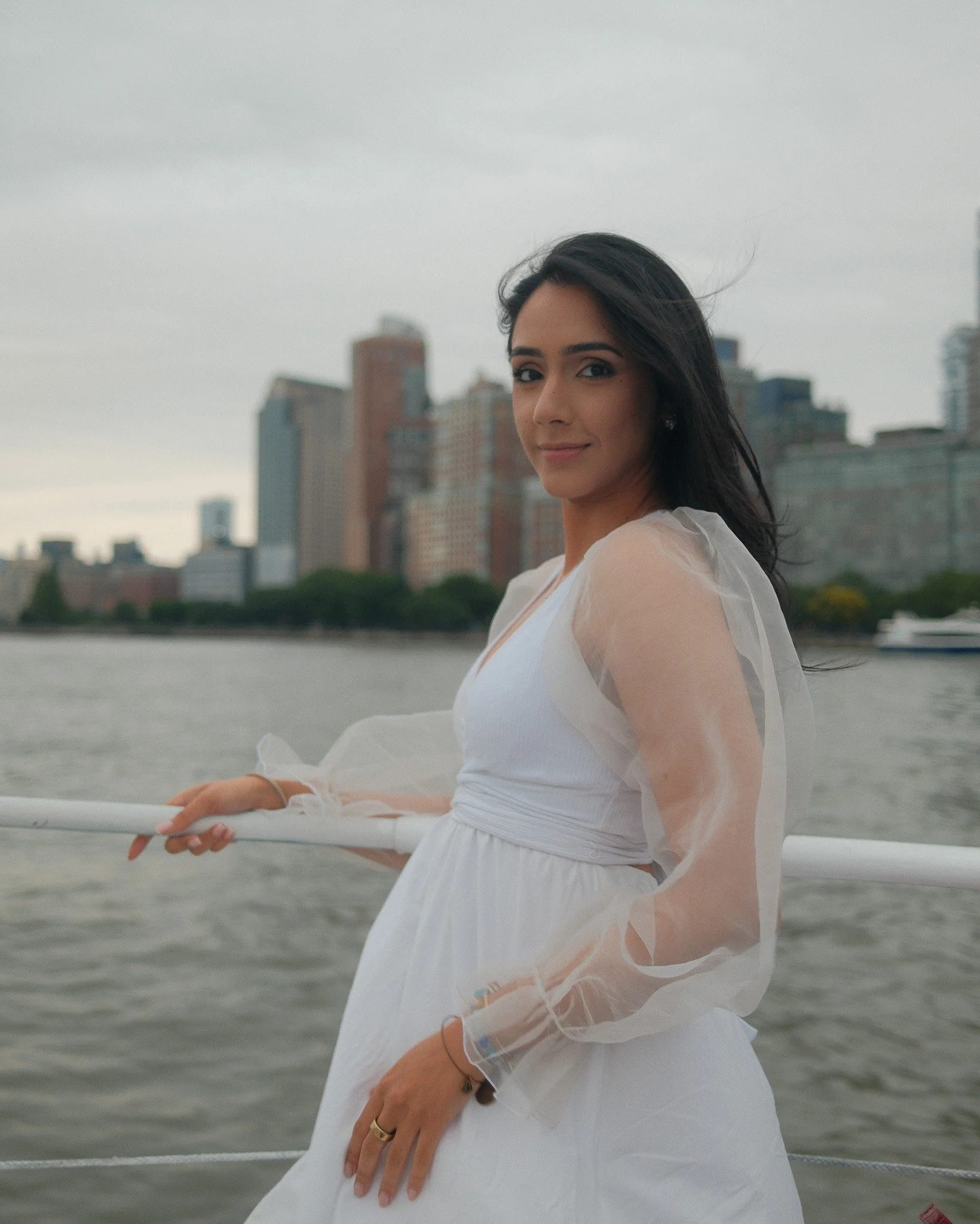 Individual portrait on a boat beside the city skyline
