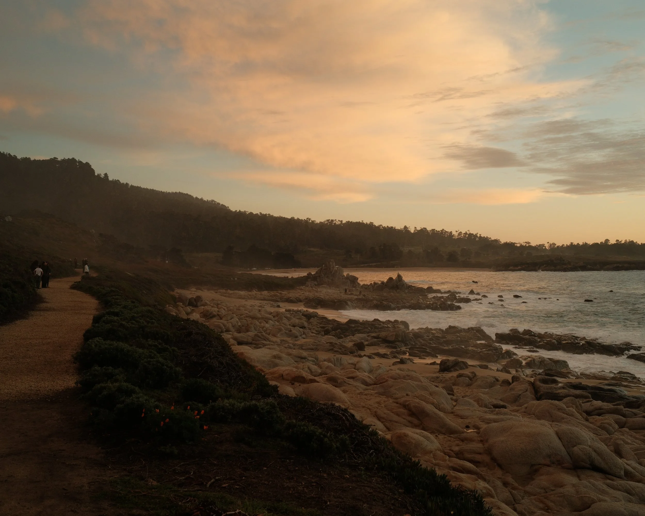Golden sky above a rocky coastline