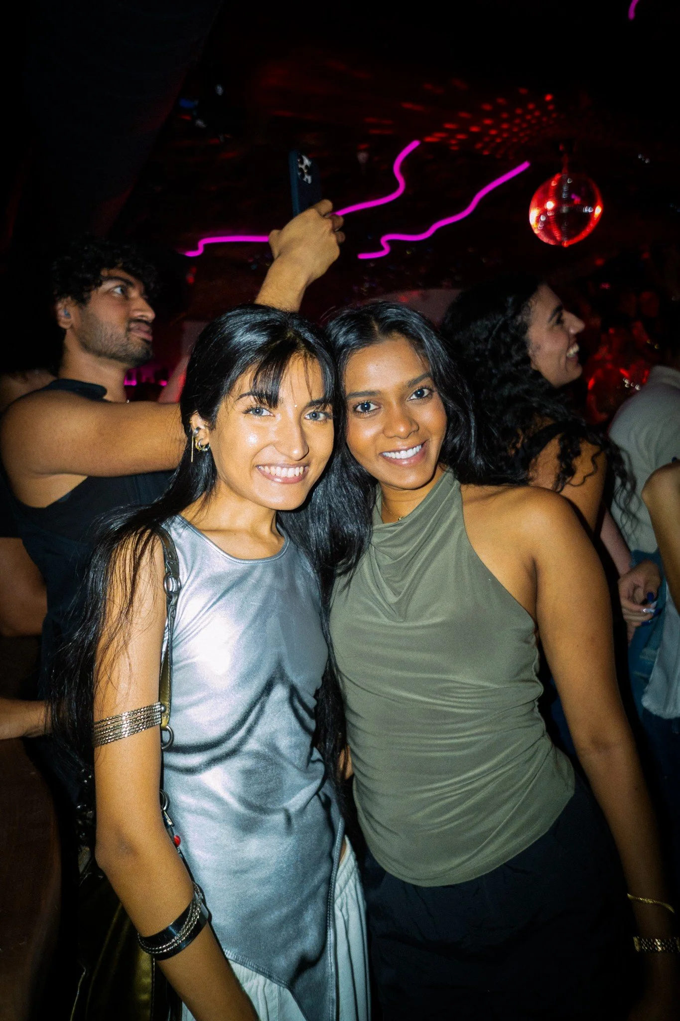 Two guests smiling at a nightlife event
