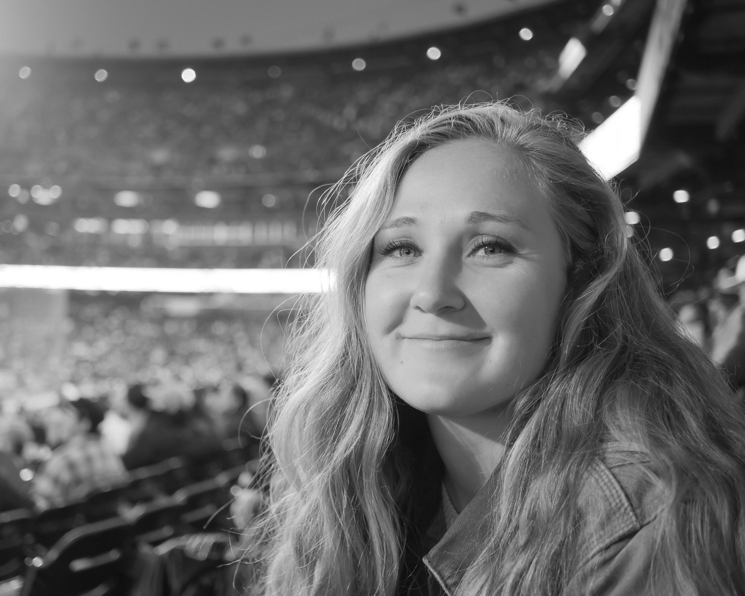 Black and white candid portrait with softly lit background