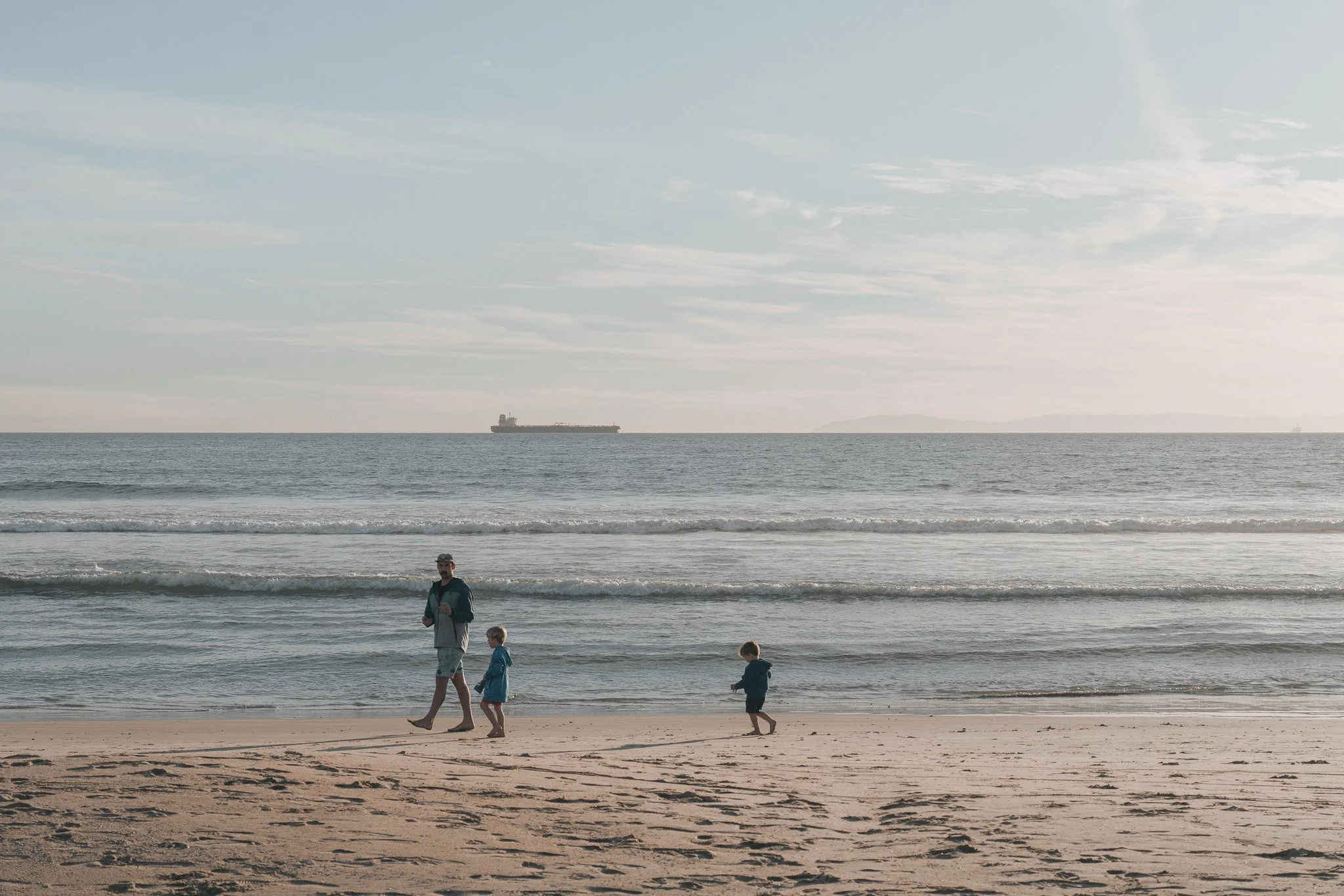 People enjoying a sunny afternoon on a broad beach