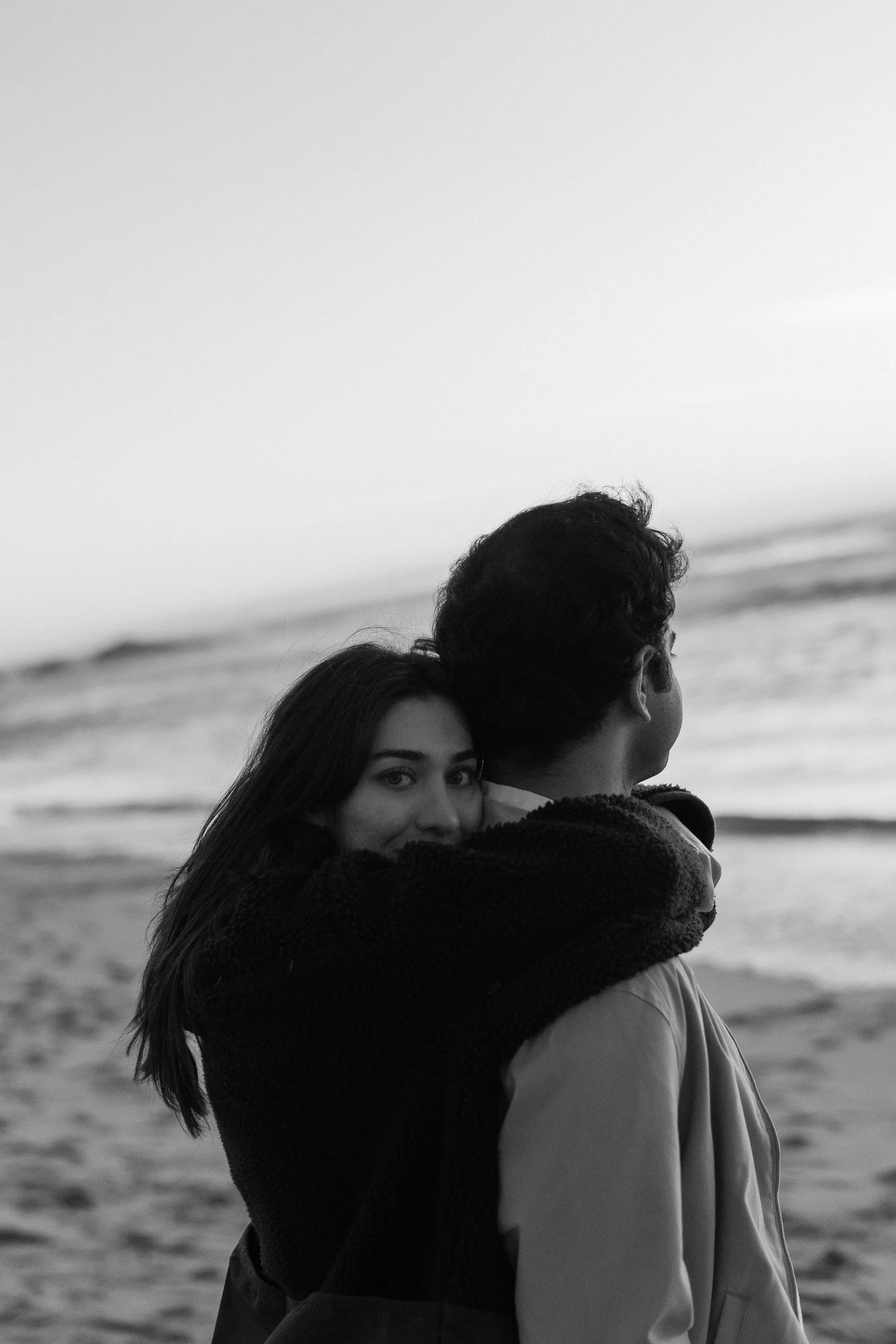 Black and white close embrace on a beach