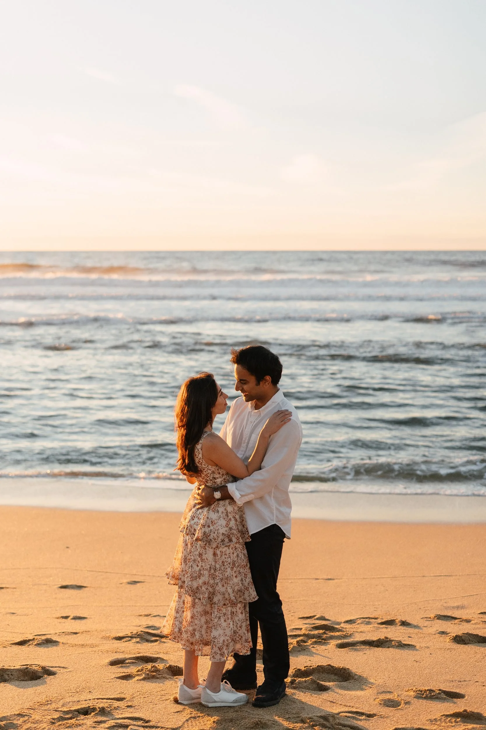 Couple embracing on a beach at sunset