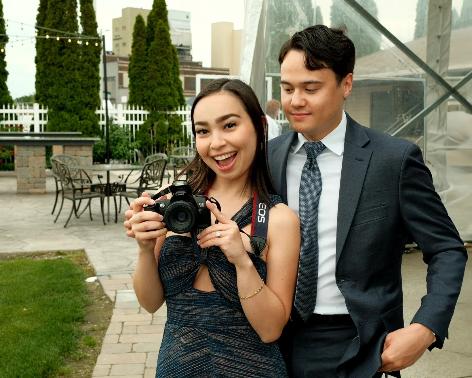 Couple holding a camera at a formal occasion