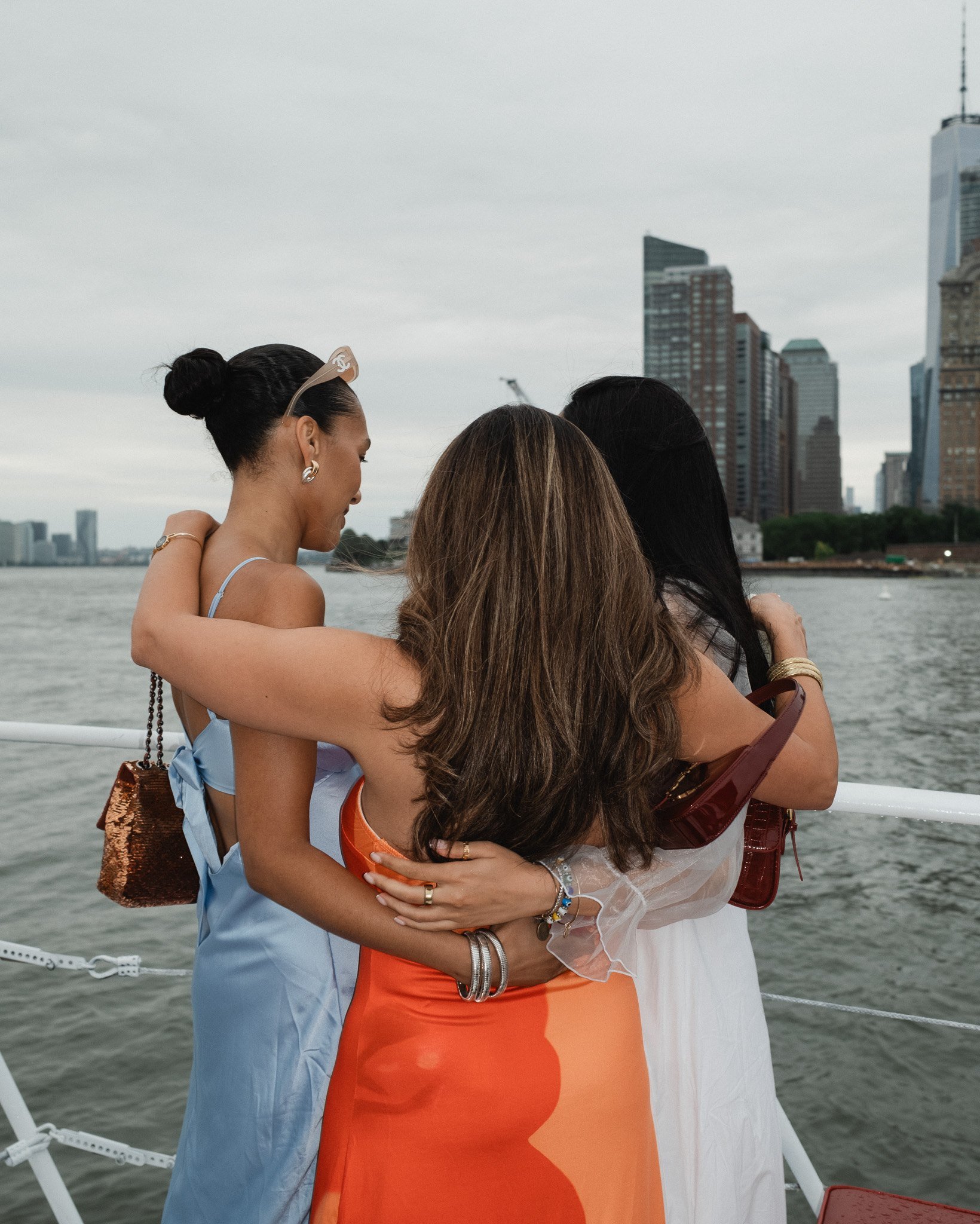 Candid friends embracing on a boat