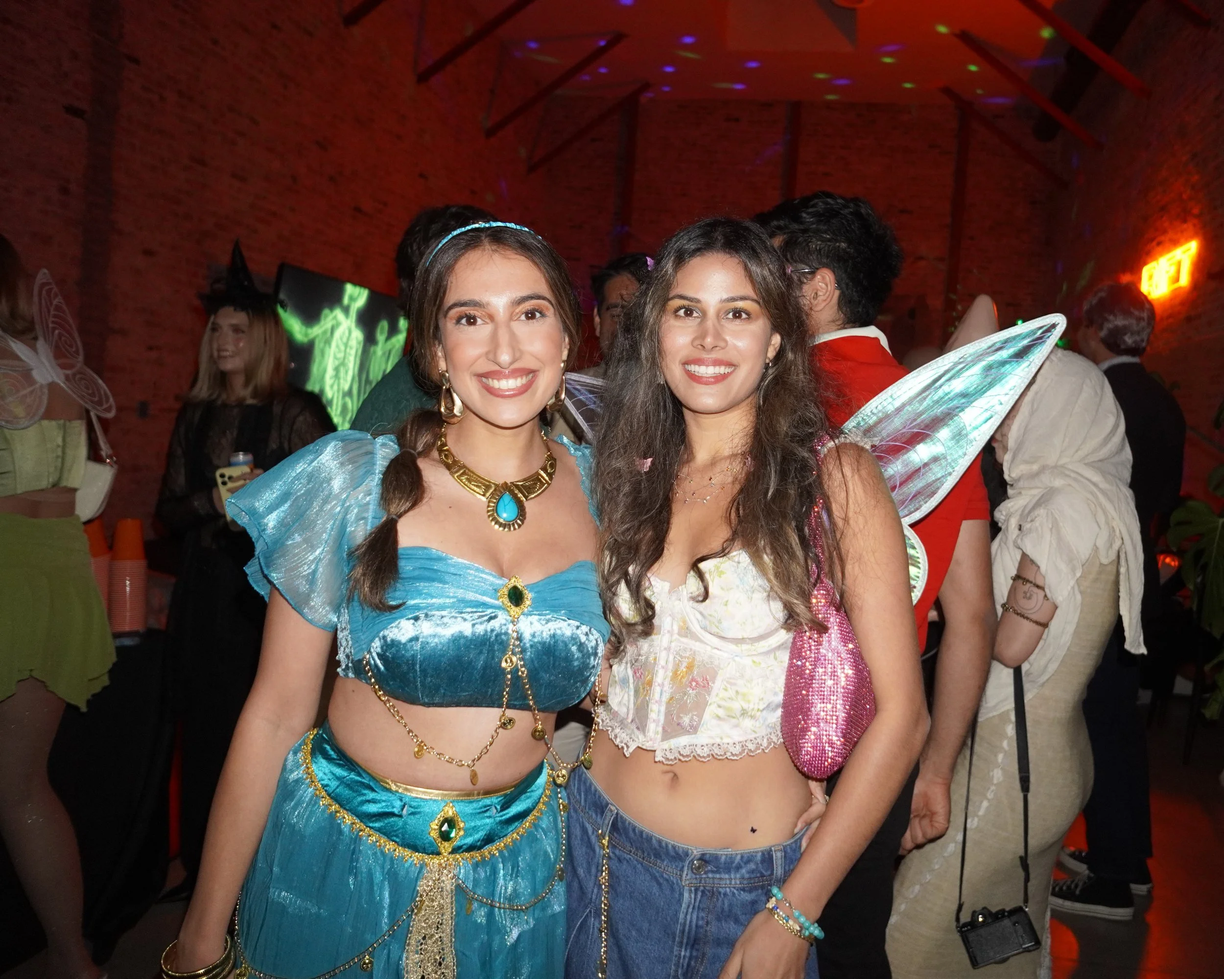 Two costumed guests at a Halloween party