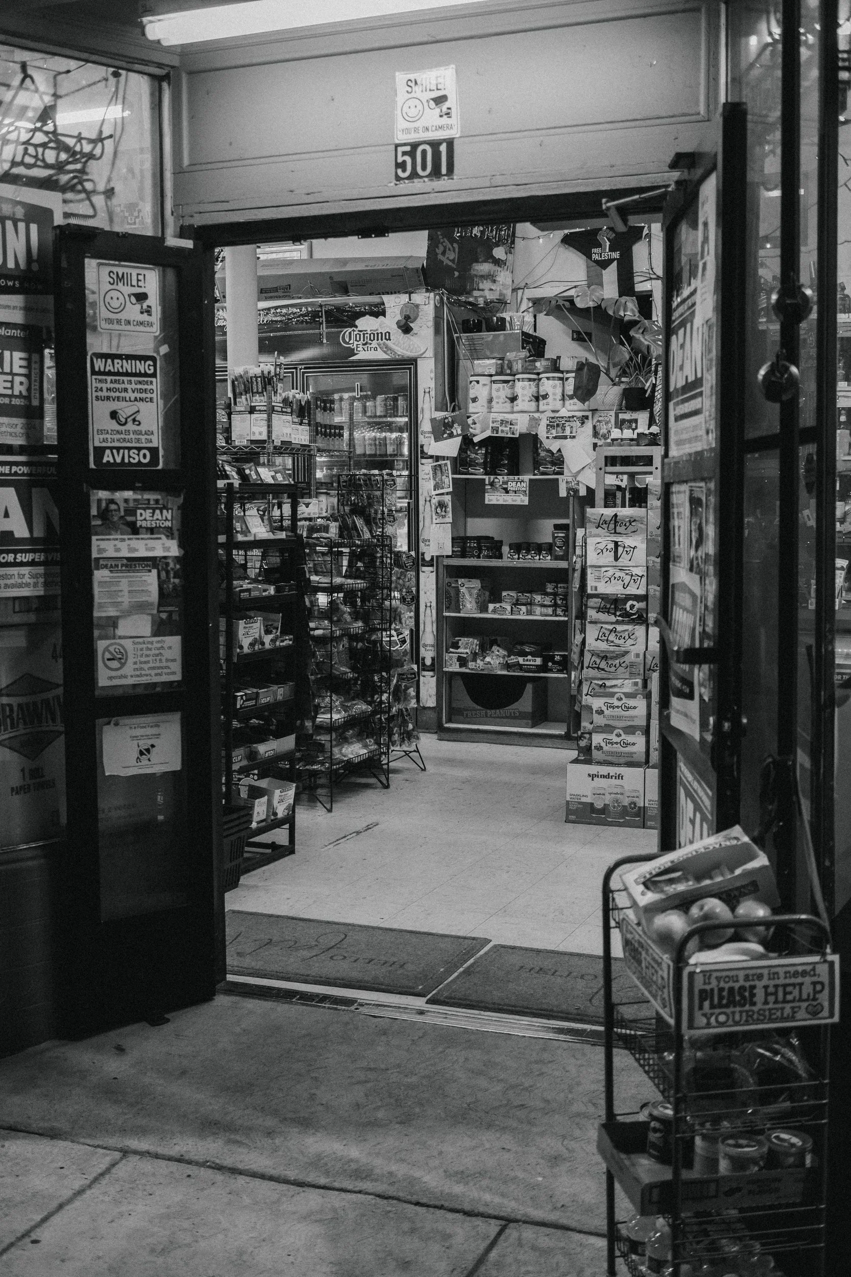 Black and white storefront with a person near the entrance