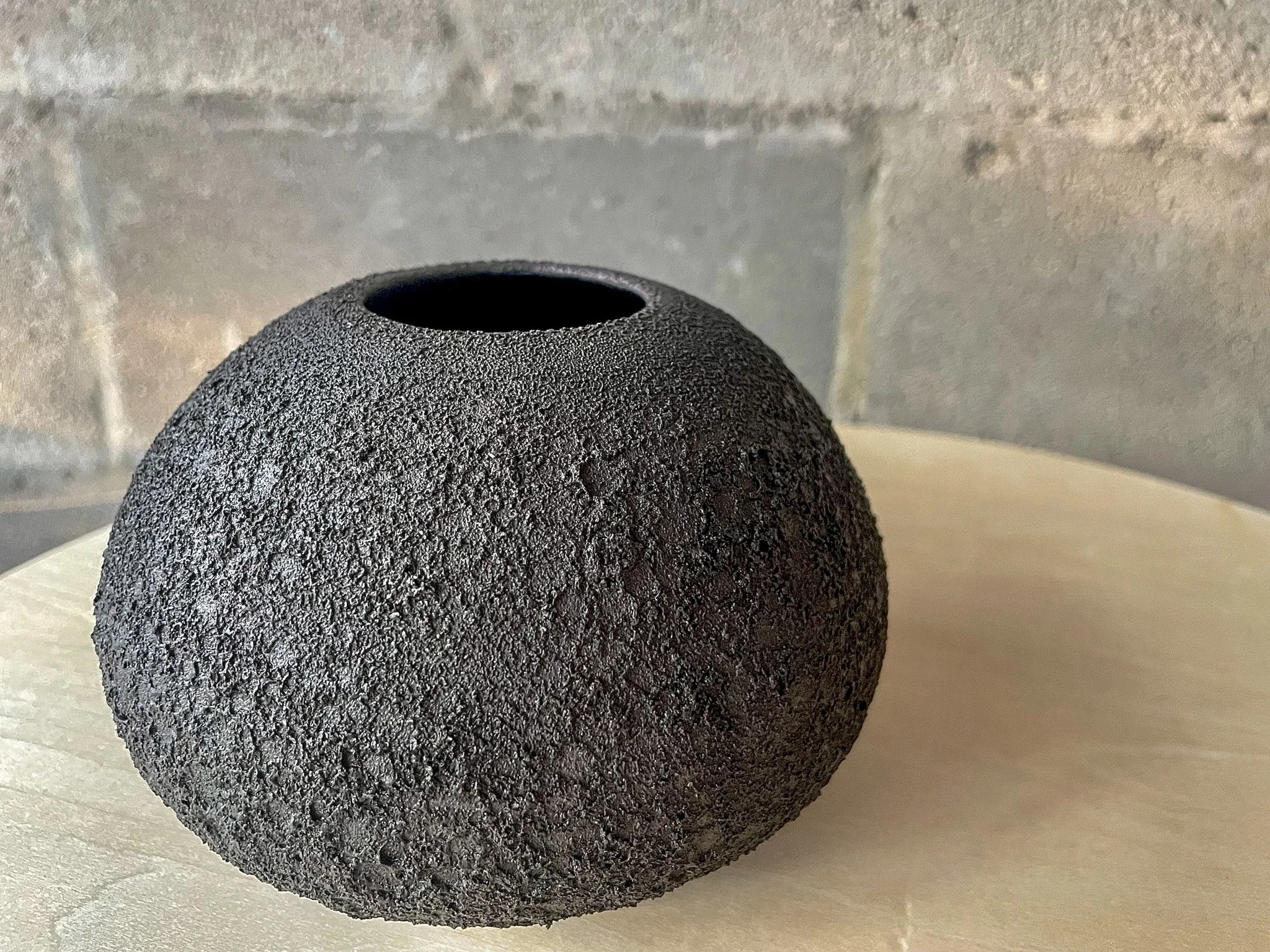 wheel-thrown stoneware flower vase in dark cratered magma glaze, handmade in Auburn Alabama
