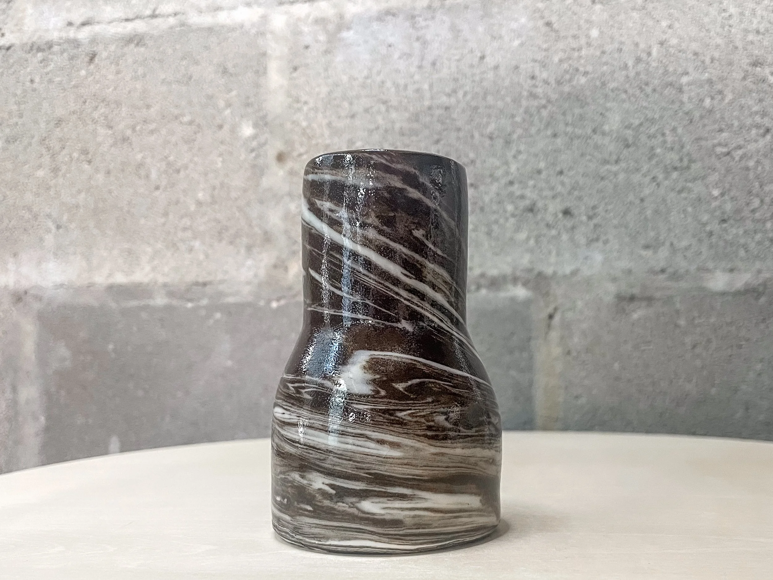 hand-glazed ceramic vessel in mixed dark and light clay, stark brutalist form, Auburn Alabama