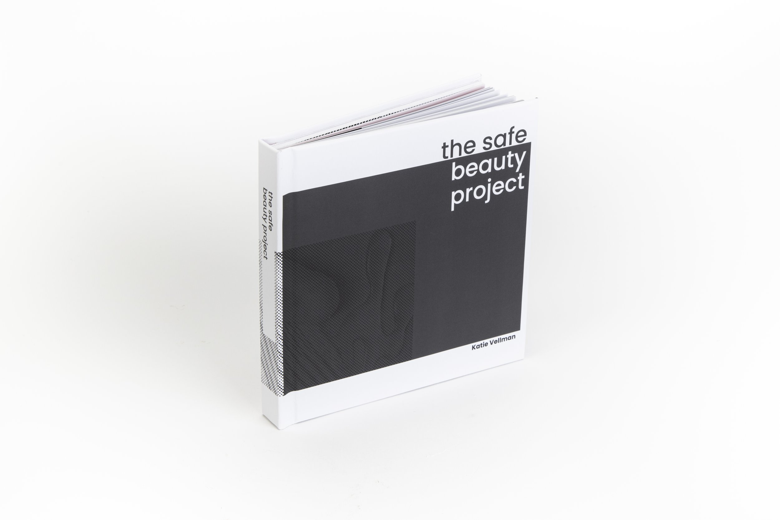 Book titled 'The Safe Beauty Project' by Katie Vellman with a minimalist black and white cover design, featuring a stylized face illustration.
