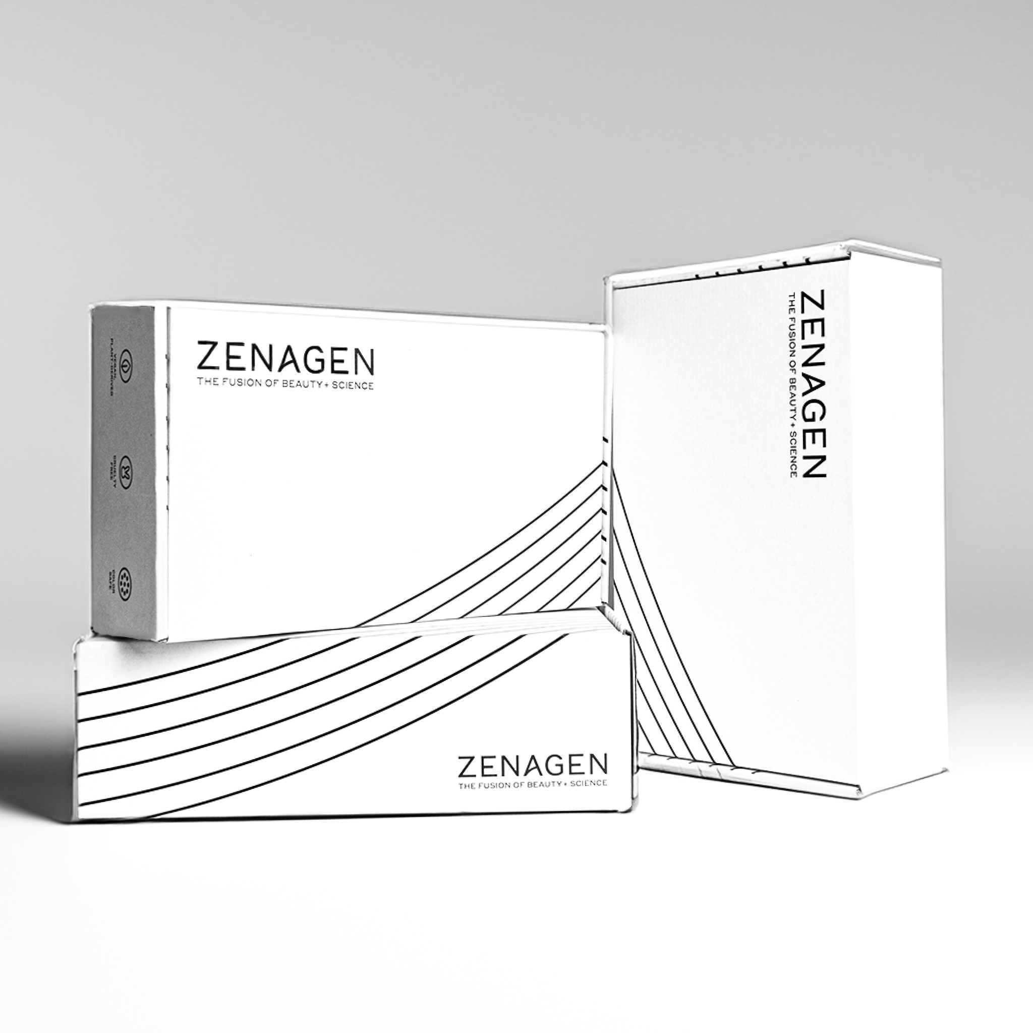 Three boxes with the brand name 'ZENAGEN' and the tagline 'THE FUSION OF BEAUTY + SCIENCE' in black text on white packaging, featuring a minimalist black line design.