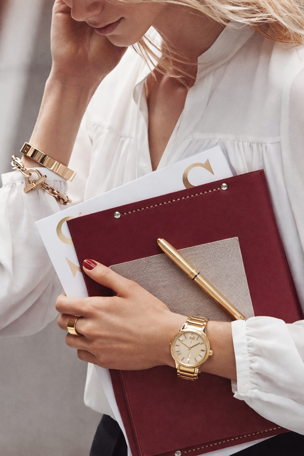 Professional woman holding financial documents and notebook, representing women managing wealth and financial planning.
