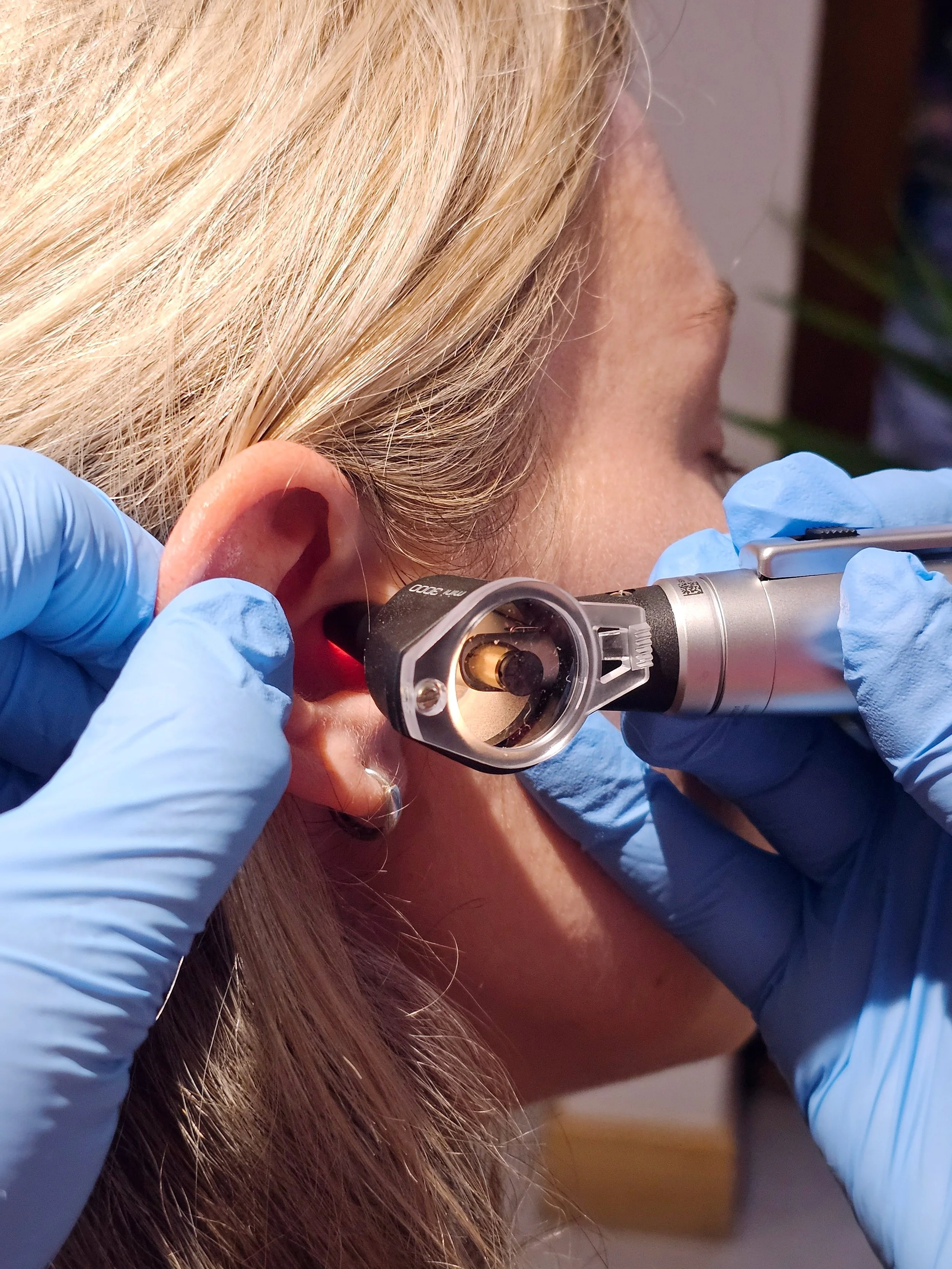 An ear check-up being performed with an ear Otoscope
