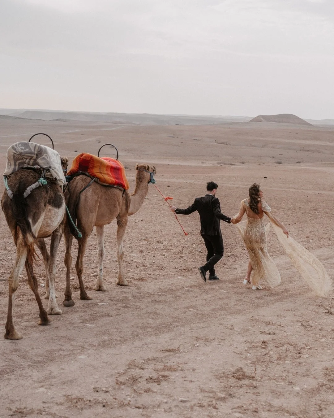 Imagine being alone in the desert, everything slowing down as the sun disappears behind the dunes. ✨
 
That&rsquo;s exactly what this pre-wedding shoot in Marrakech felt like. Warm light, soft sand under your feet, camels in the distance, and that mo