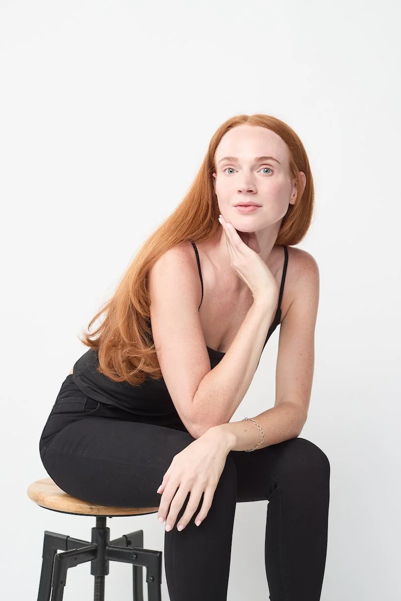 Taylor VanBebber, seated portrait against a white background.